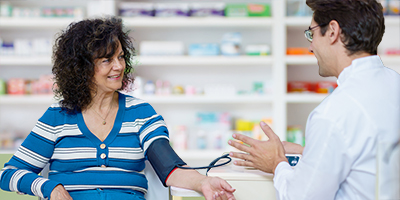 woman in pharmacy getting blood pressure check